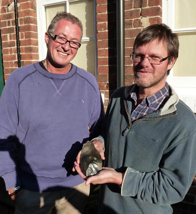 Nick Ashton (right) with a Palaeolithic handaxe brought in to a  museum open day