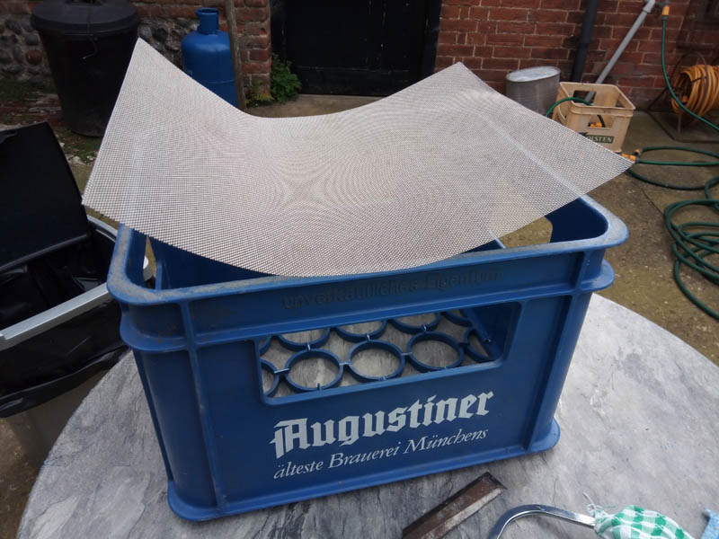 Cut the mesh 1 cm larger that the inside of the sieve