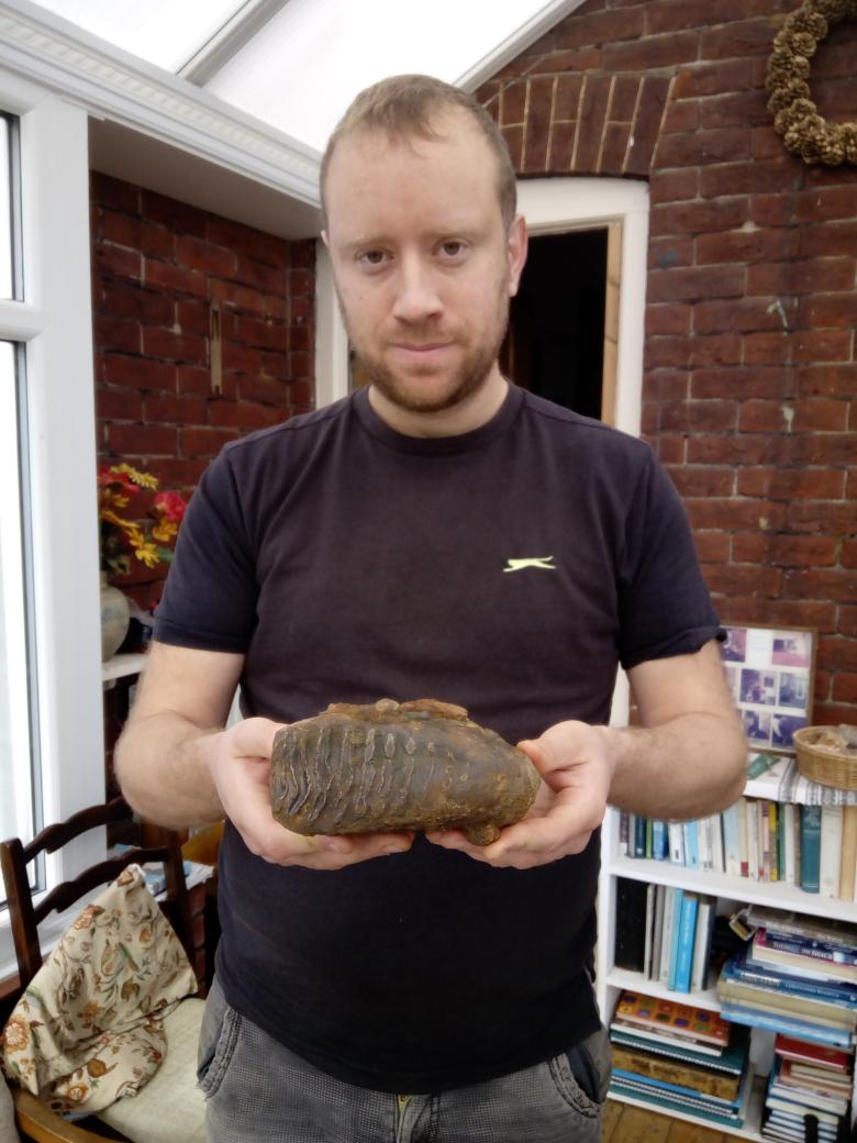 Jonathan Stewart with a mammoth molar discovered in 2017
